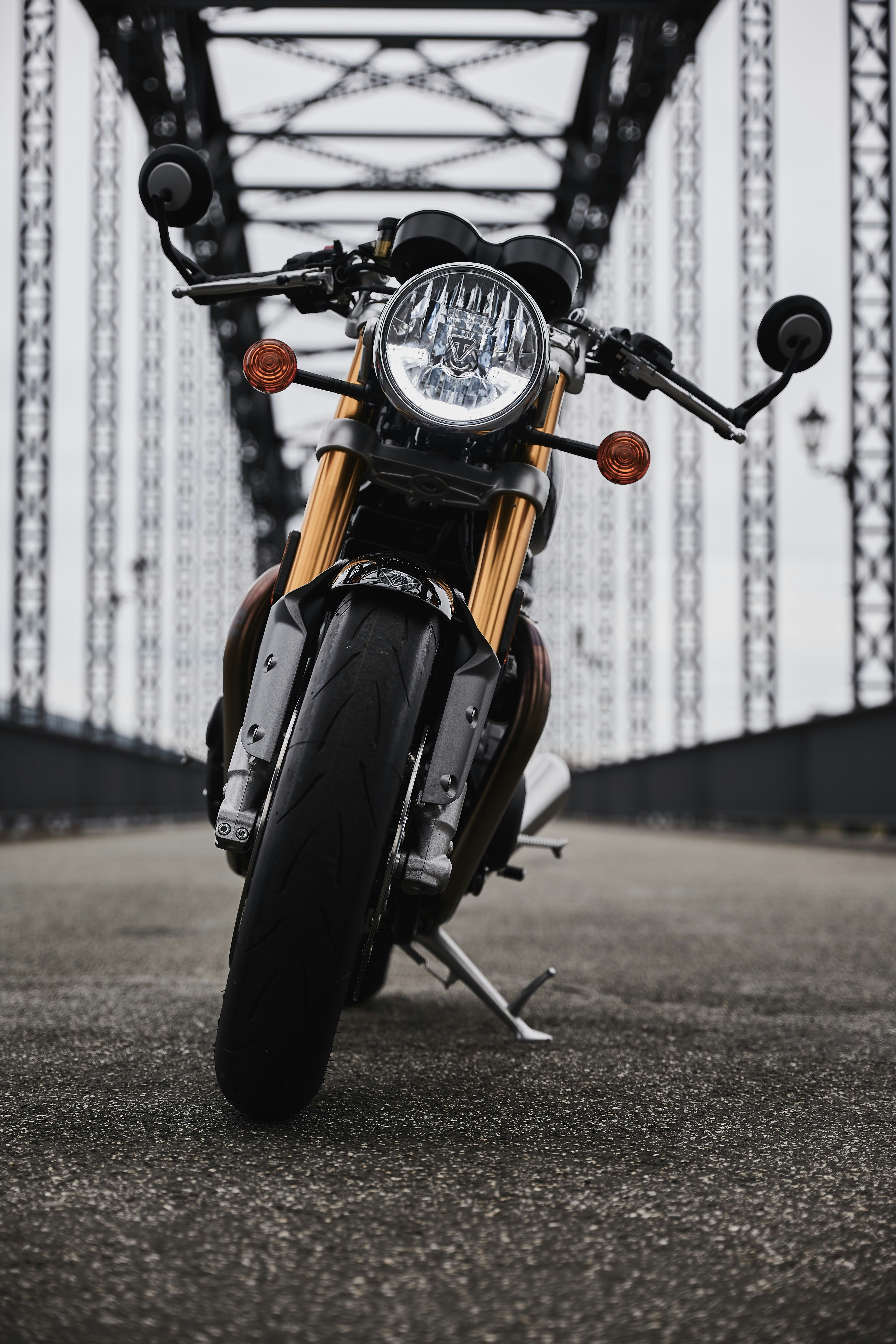 orange and black motorcycle on road during daytime